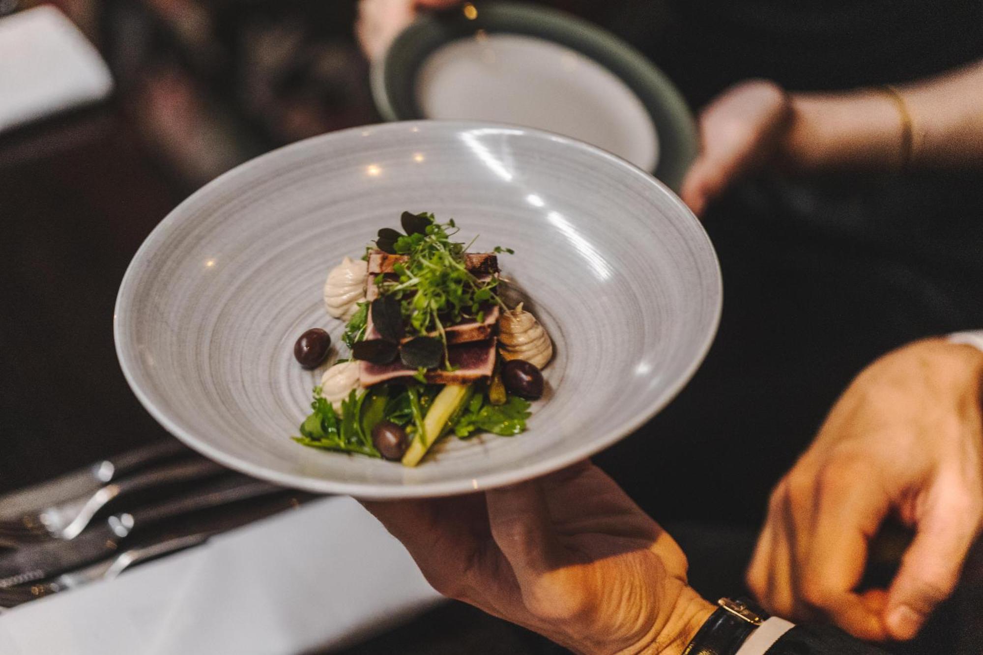 Hotel Pigalle Gothenburg Bagian luar foto A server holding a plate of food